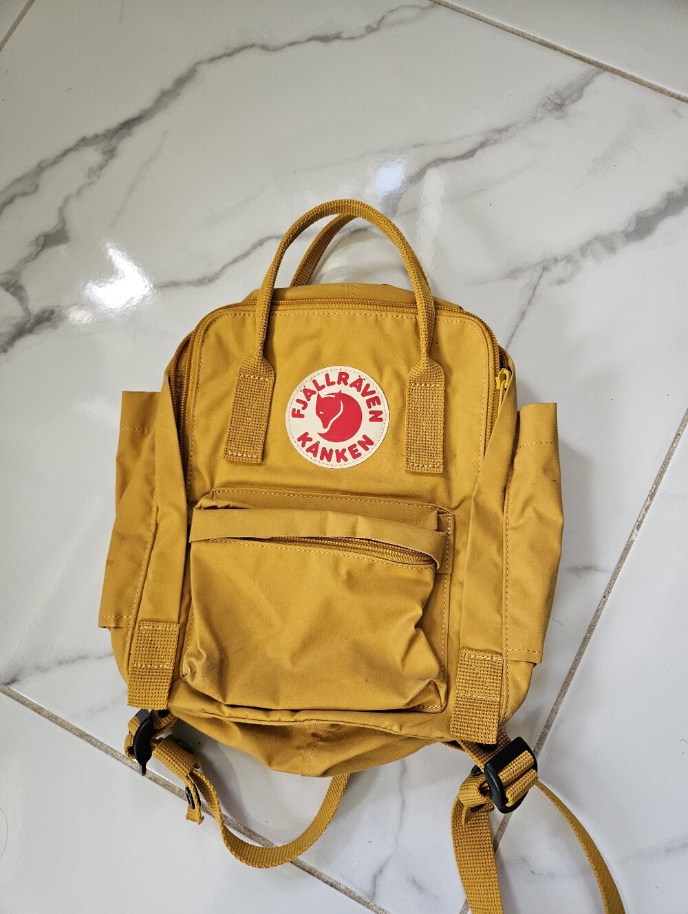 Fjällräven Kånken meduim yellow backpack.